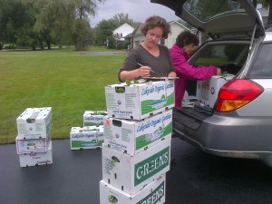 Allison and Karen weigh and record each box of food.